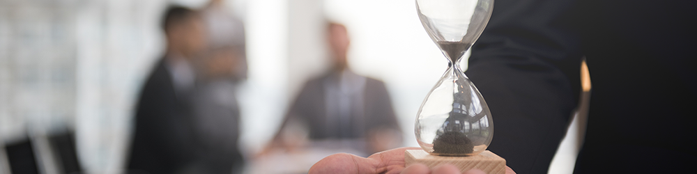 Holiday Pay Claim Time Limits outlined by Employment Law Friend. Someone holds an egg timer in their palm, while a claimant and their solicitor sit at a meeting table in the background. Holiday Pay Claim Time Limits outlined by Employment Law Friend. Someone holds an egg timer in their palm, while a claimant and their solicitor sit at a meeting table in the background.